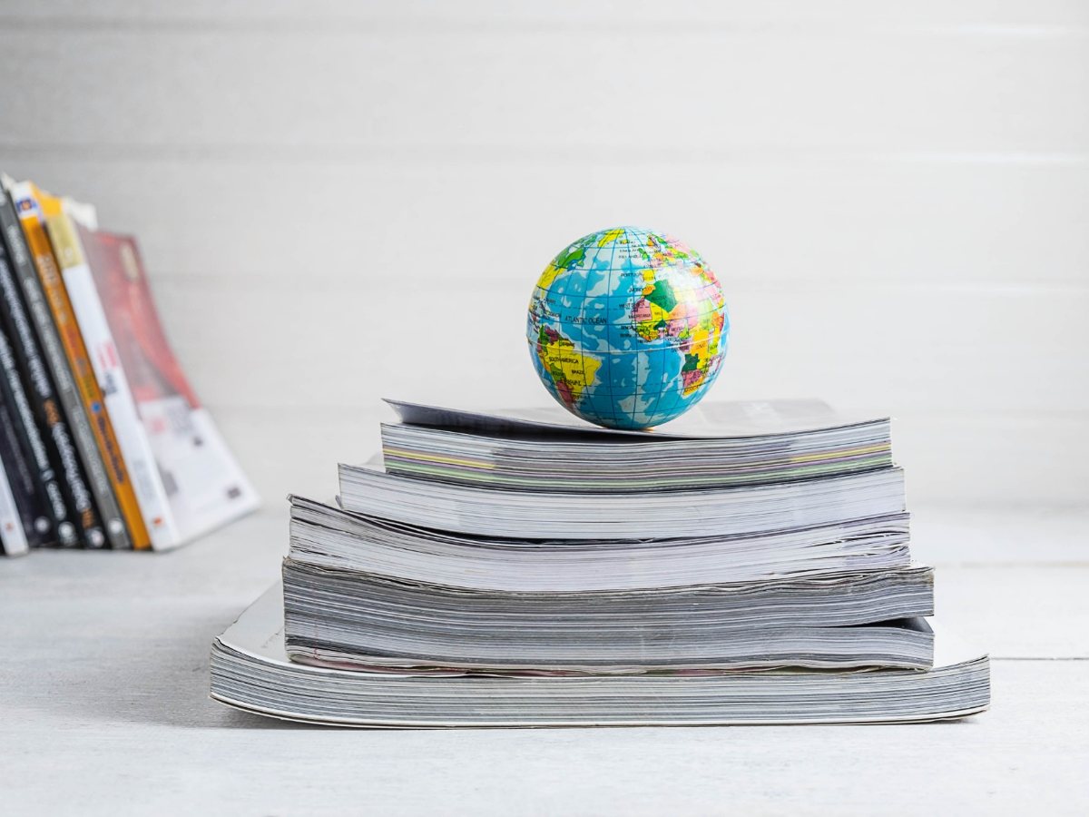 Small globe resting on a stack of reference books
